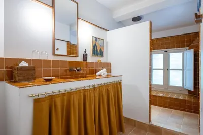a bathroom with a sink and a faucet at Le Moulin, Lourmarin, a Beaumier Hotel in Lourmarin