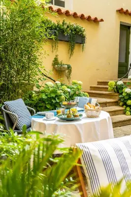 a table with food on it in a garden at La Maison d'été in Salon-de-Provence