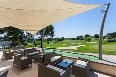 a view of the golf course from the patio of a resort at Madame Vacances Résidence Provence Country Club in Saumane-de-Vaucluse
