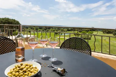 a table with glasses of wine and a bowl of olives at Madame Vacances Résidence Provence Country Club in Saumane-de-Vaucluse