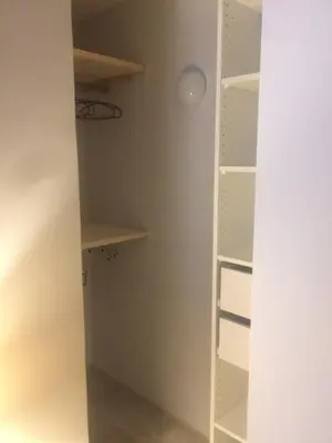 a walk in closet with white shelves at Chez Adeline in Céreste