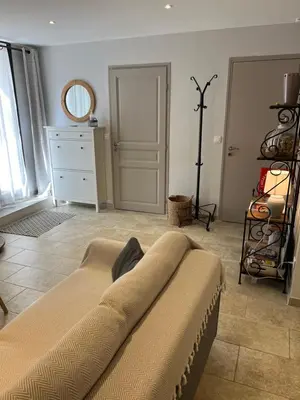 a living room with a couch and a dresser at Chez Adeline in Céreste