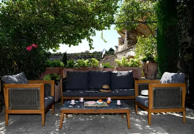 a patio with a couch and two chairs and a table at Le Bonheur in Gordes