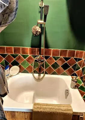 a bathroom with a sink with a hair dryer at Fenêtre sur vue in Saignon