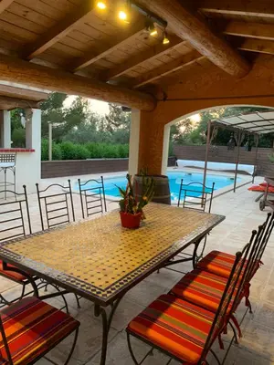 a patio with a table and chairs and a pool at La Campanette en Luberon -Piscine privée in Cheval-Blanc