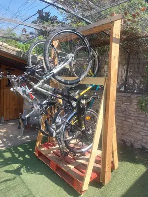 a group of bikes on a wooden rack at Villa - La quiétude de St Antoine - piscine privée in LʼIsle-sur-la-Sorgue
