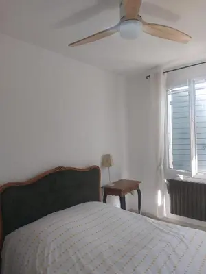 a bedroom with a bed and a ceiling fan at Villa - La quiétude de St Antoine - piscine privée in LʼIsle-sur-la-Sorgue