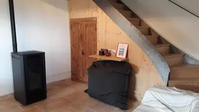 a room with a staircase with a bed and a table at Gîte du Mas Saint-Victor in Bonnieux