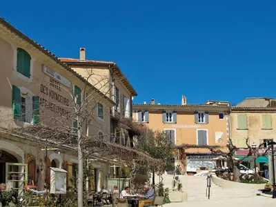 a group of people sitting outside of a building at Holiday Home Les Huppes by Interhome in Saint-Saturnin-les-Apt