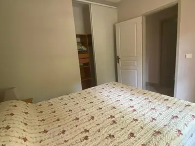 a bedroom with a bed with a comforter on it at La Manaude in Ménerbes