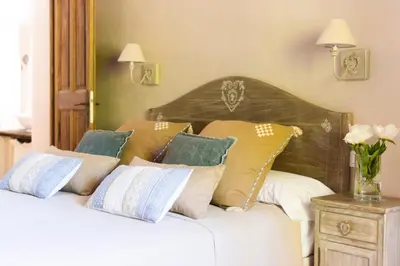 a bedroom with a bed with pillows on it at Le Mas Silvestre in Saint-Saturnin-les-Apt