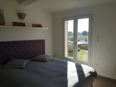 a bedroom with a bed and a large window at maison Moliere in Aix-en-Provence