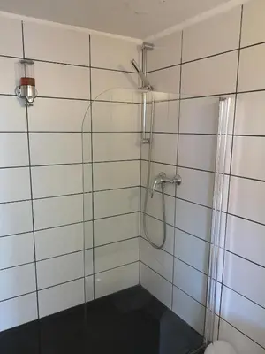 a bathroom with a shower with a glass door at maison Moliere in Aix-en-Provence