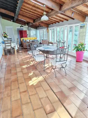 a dining room with a table and chairs on a tile floor at Villa spacieuse à Lioux avec piscine privée et vue montagne in Lioux