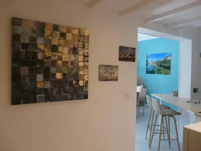 a kitchen with three pieces of art on the wall at Bleu de l'Isle in LʼIsle-sur-la-Sorgue