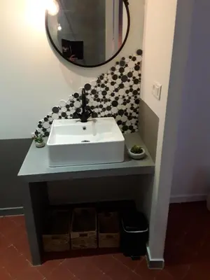 a bathroom with a sink and a mirror at Le Clos Marceau in Bédoin