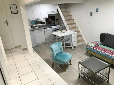 a living room with a couch a table and a kitchen at Le calme et la tranquilité à 15 minutes d'Avignon in Caumont-sur-Durance