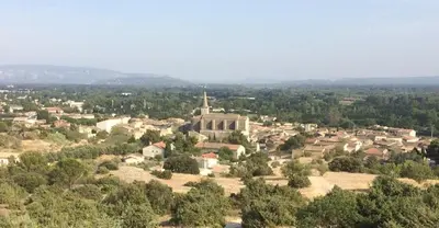 an aerial view of a small town with a church at Le calme et la tranquilité à 15 minutes d'Avignon in Caumont-sur-Durance