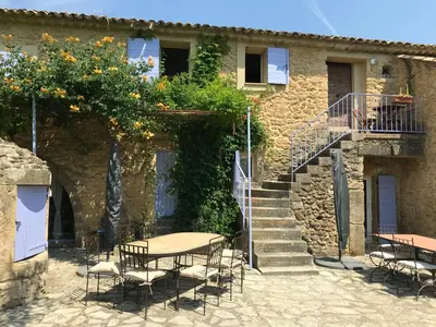 a table and chairs in front of a building at Bastide du Buou in Puyvert