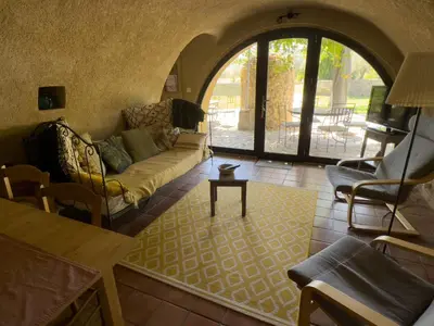a living room with a couch and a table at Bastide du Buou in Puyvert