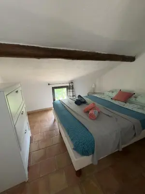 a bedroom with two beds and a window at Bastide du Buou in Puyvert