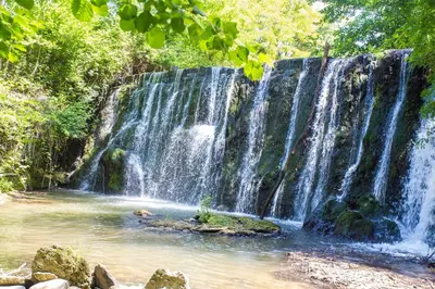 a waterfall in the middle of a forest at Domaine en Provence Gîte la Ferrandiere in Carpentras