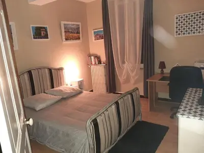 a bedroom with a bed and a desk in it at le Mas d'Hubert in LʼIsle-sur-la-Sorgue