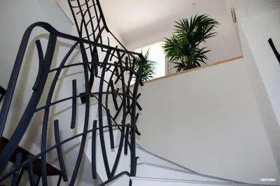 a spiral staircase in a house with plants at BASTIDE 9 in La Fare-les-Oliviers