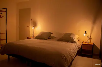 a bedroom with a large bed with two pillows at BASTIDE 9 in La Fare-les-Oliviers