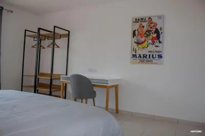a bedroom with a desk and a movie poster on the wall at BASTIDE 9 in La Fare-les-Oliviers