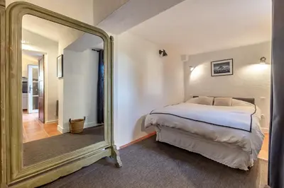 a bedroom with a bed and a large mirror at Mas OREA in Gordes