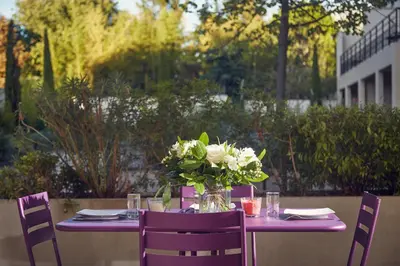 a balcony with purple chairs and a table at Aparthotel Adagio Aix-en-Provence Centre in Aix-en-Provence