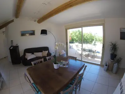a living room with a wooden table and a couch at LA MAGUETTE in Sault-de-Vaucluse