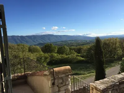 a balcony with a view of a mountain at La Bastide de Ninou maison de vacances Luberon in Viens