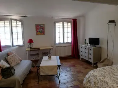 a bedroom with a bed and a desk with a tv at Studio ensoleillé, typique centre historique, wifi in Aix-en-Provence