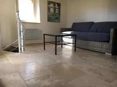 a living room with a couch and a table at La Magnanerie in Bonnieux