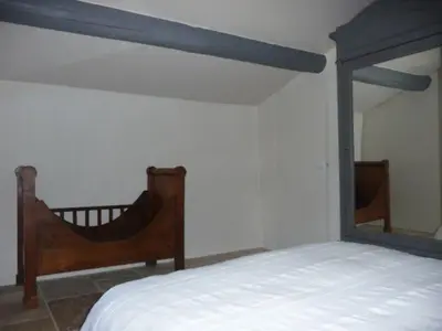 a bedroom with a bed and a mirror at La Magnanerie in Bonnieux