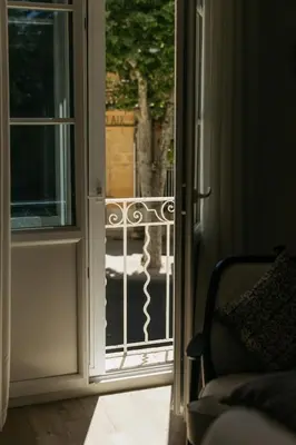 an open door with a view of a balcony at Hôtel Boutique Cézanne centre Aix-en-Provence in Aix-en-Provence