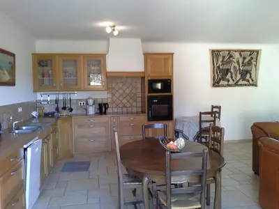 a kitchen with a table and a dining room at Domaine de la Marie dans le Luberon in Peypin-dʼAigues