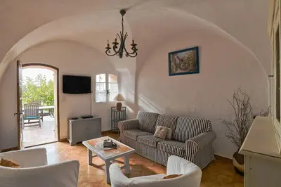 a living room with a couch and a table at Domaine de la Marie dans le Luberon in Peypin-dʼAigues