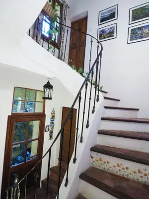 a staircase in a home with white walls at Cent Cinq - unique apartments in the heart of Apt in Apt