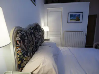 a bedroom with a bed with a head board at Cent Cinq - unique apartments in the heart of Apt in Apt
