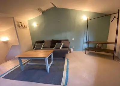 a small room with a bed and a door at Charmante maison en centre ville d'Apt in Apt