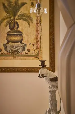 a picture of a painting and a statue in a room at Le Pigonnet - Esprit de France in Aix-en-Provence