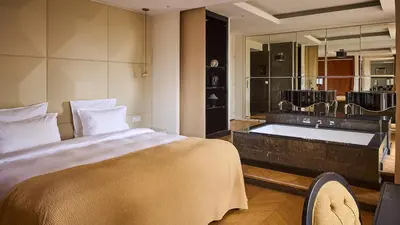 a bedroom with a large bed and a bath tub at Le Pigonnet - Esprit de France in Aix-en-Provence