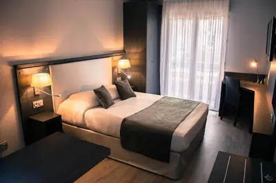 a hotel room with a bed and a window at Séjours & Affaires Aix-en-Provence Mirabeau in Aix-en-Provence