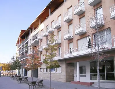 a large building with benches in front of it at Séjours & Affaires Aix-en-Provence Mirabeau in Aix-en-Provence