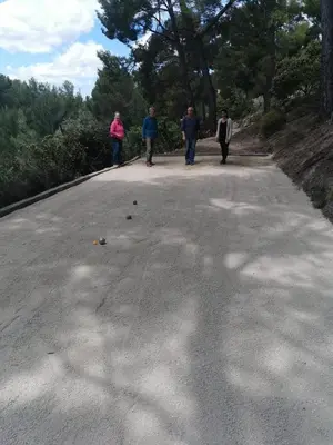 a group of people walking down a road at Le Mas des Roches à Velaux in Velaux