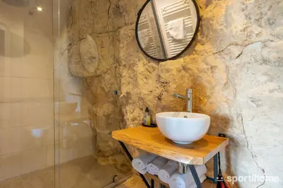 a bathroom with a sink and a mirror at Le Mas des Roches à Velaux in Velaux