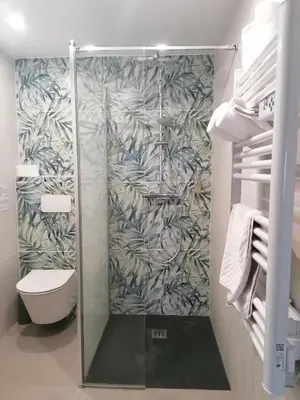 a shower with a glass door in a bathroom at Le Mas des Roches à Velaux in Velaux